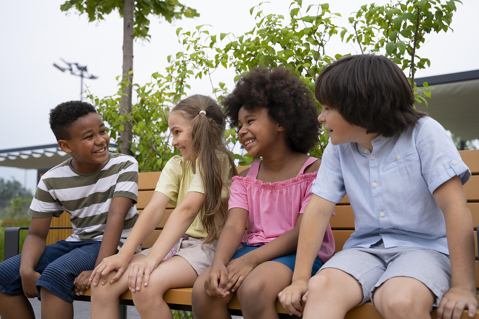 medium-shot-smiley-kids-sitting-bench